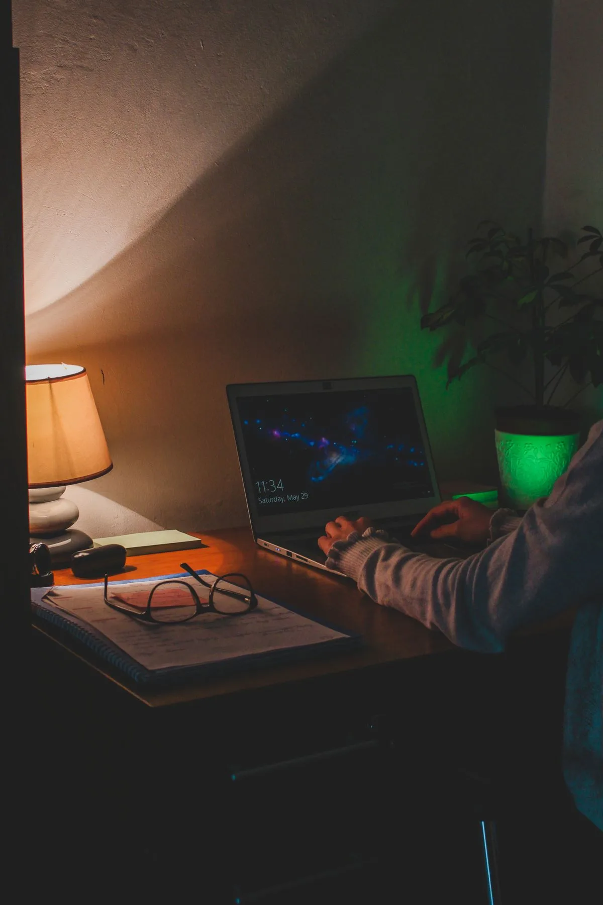 Person working productively late at night in dimly lit room — evening chronotype