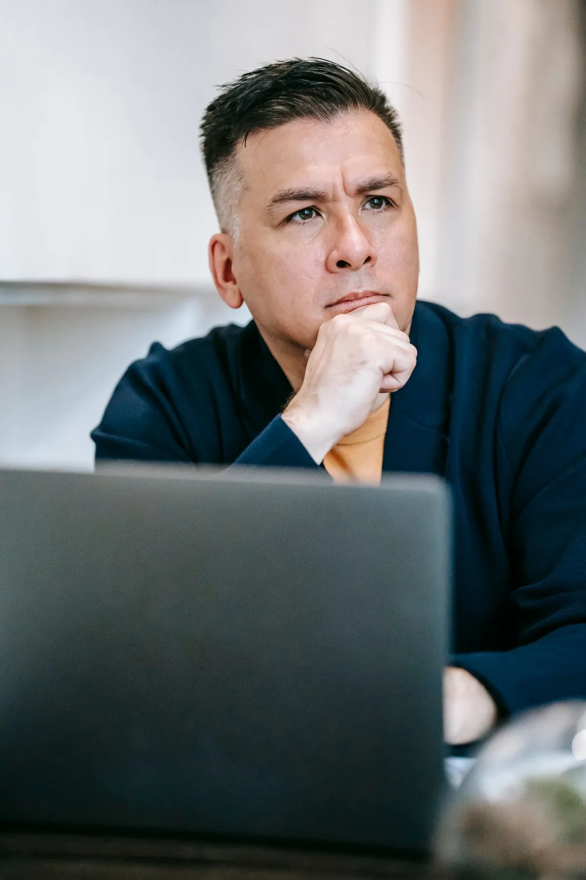 Focused man working on laptop in deep concentration — cognitive peak hours productivity