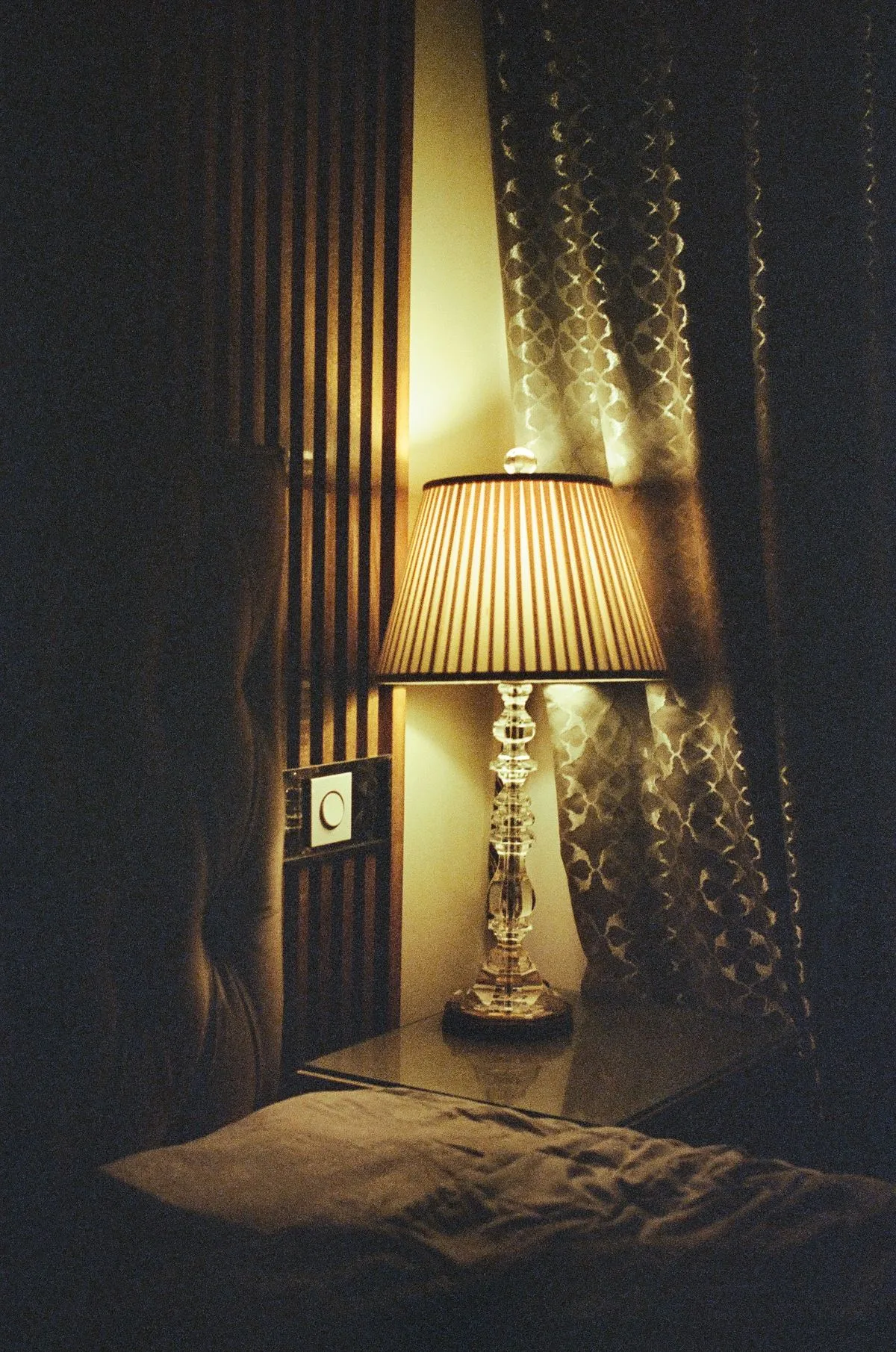 Cozy bedroom with warm bedside lamp — evening light and circadian wind-down routine